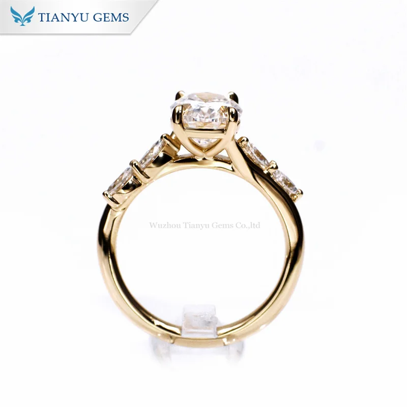 Tianyu gems yellow gold Oval centre diamond with Marquise cut stones on the shoulders engagement ring
