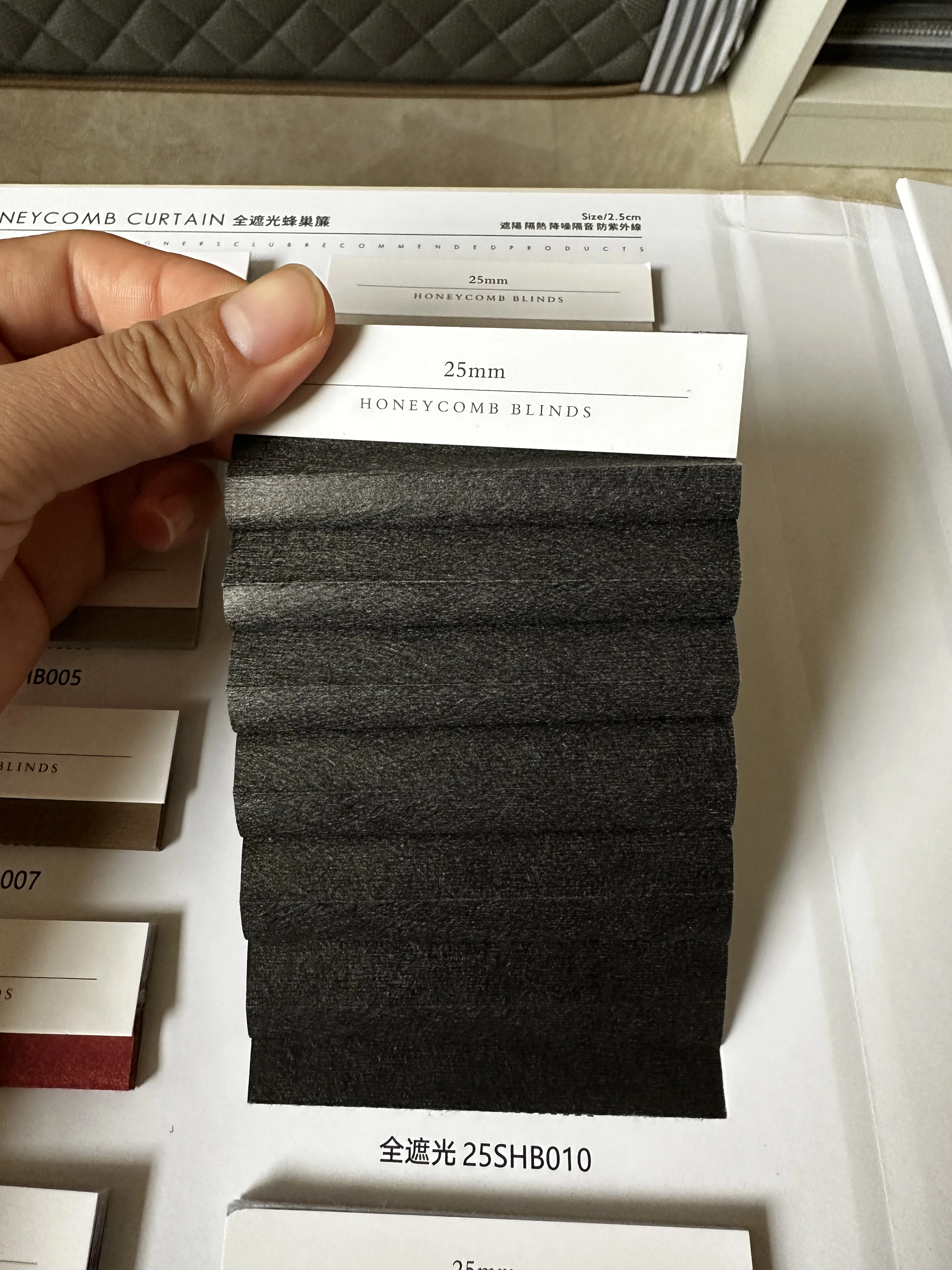 Cordless black color blackout cellular blind