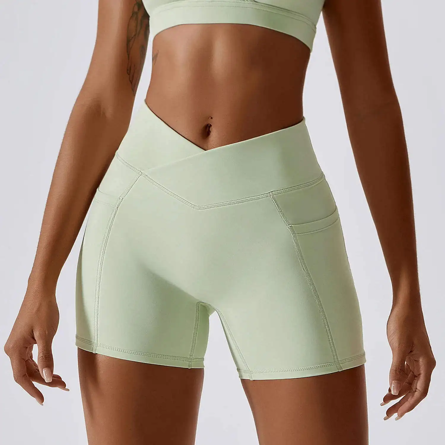 Oem Sportswear Quick Dry Nude Hip-lifting Pocket Solid Color Running Fitness Shorts Crossed Waist Tight Yoga Shorts