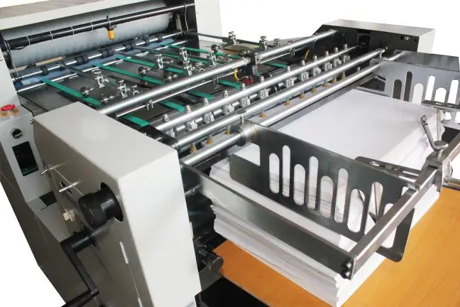 Embossing machine for embossing patterns on paper surface