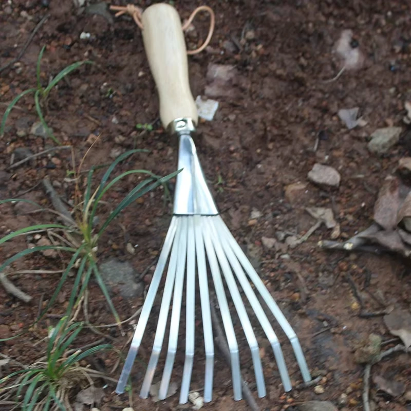 Stainless steel three toothed rake and flower