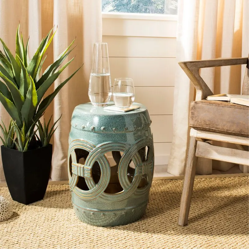 The modern Chinese side table is exquisitely made of green ceramics. The hollow shape can be placed in any space.