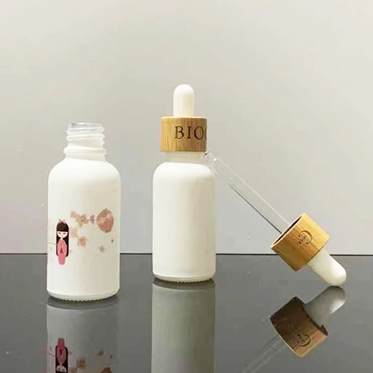 Hot sale luxury custom 10Ml 30ml frosted matte white cosmetic glass serum essential oil bottle with gold dropper and paper tube