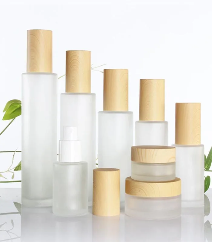 Wholesale cosmetic bottle glass jars skin care packaging set frost cream jars and spray lotion bottles with bamboo lid