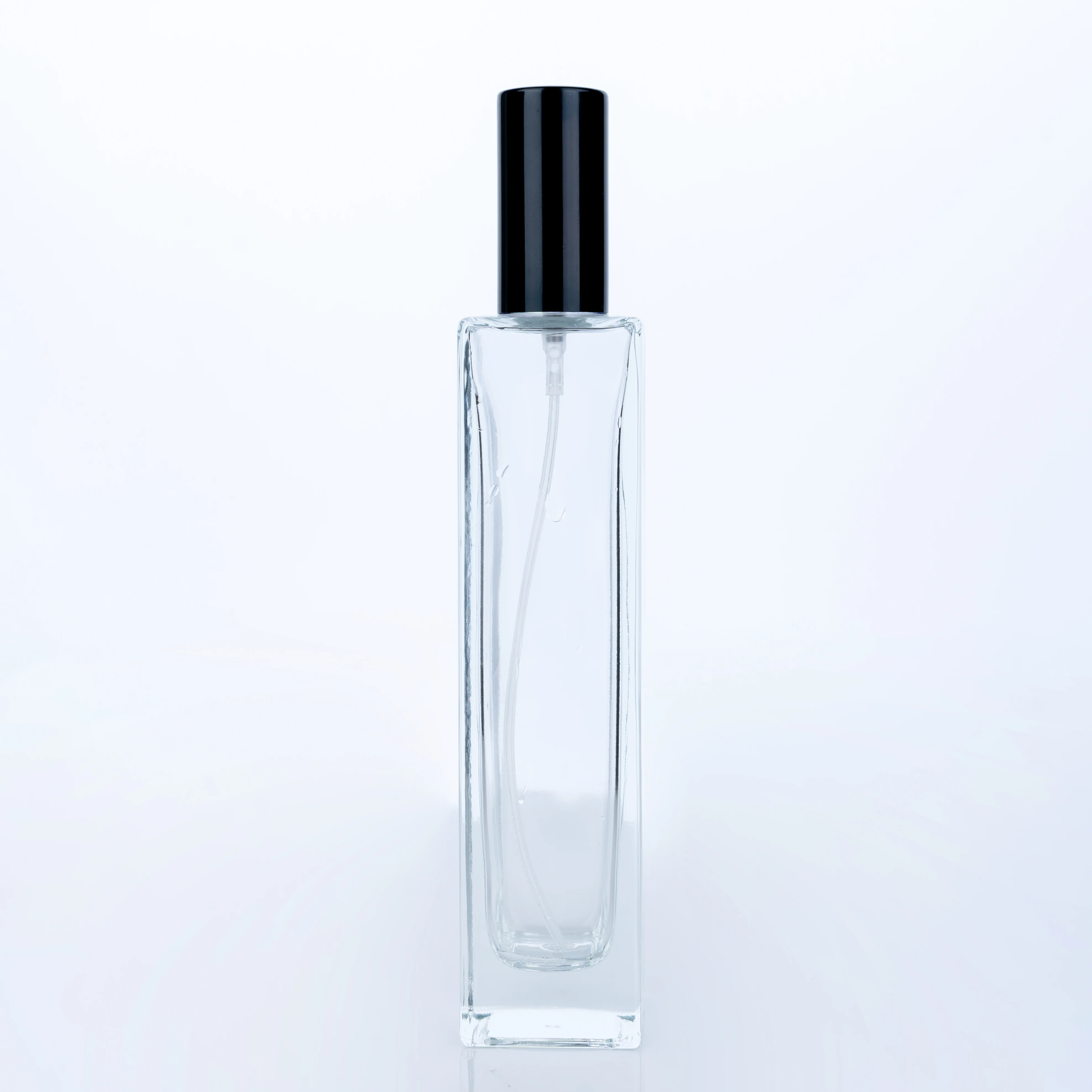 
The Customized High Quality 100ml Transparent Bottle With Black Round Cap Square Tall Perfume Bottle 