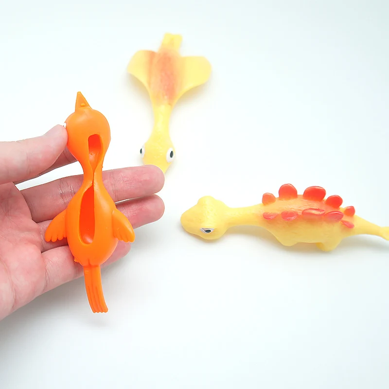 Hot Sale TPR Material High Quality Promotion TPR Dinosaur Toy Slingshot Catapult Toys Small Children Toys