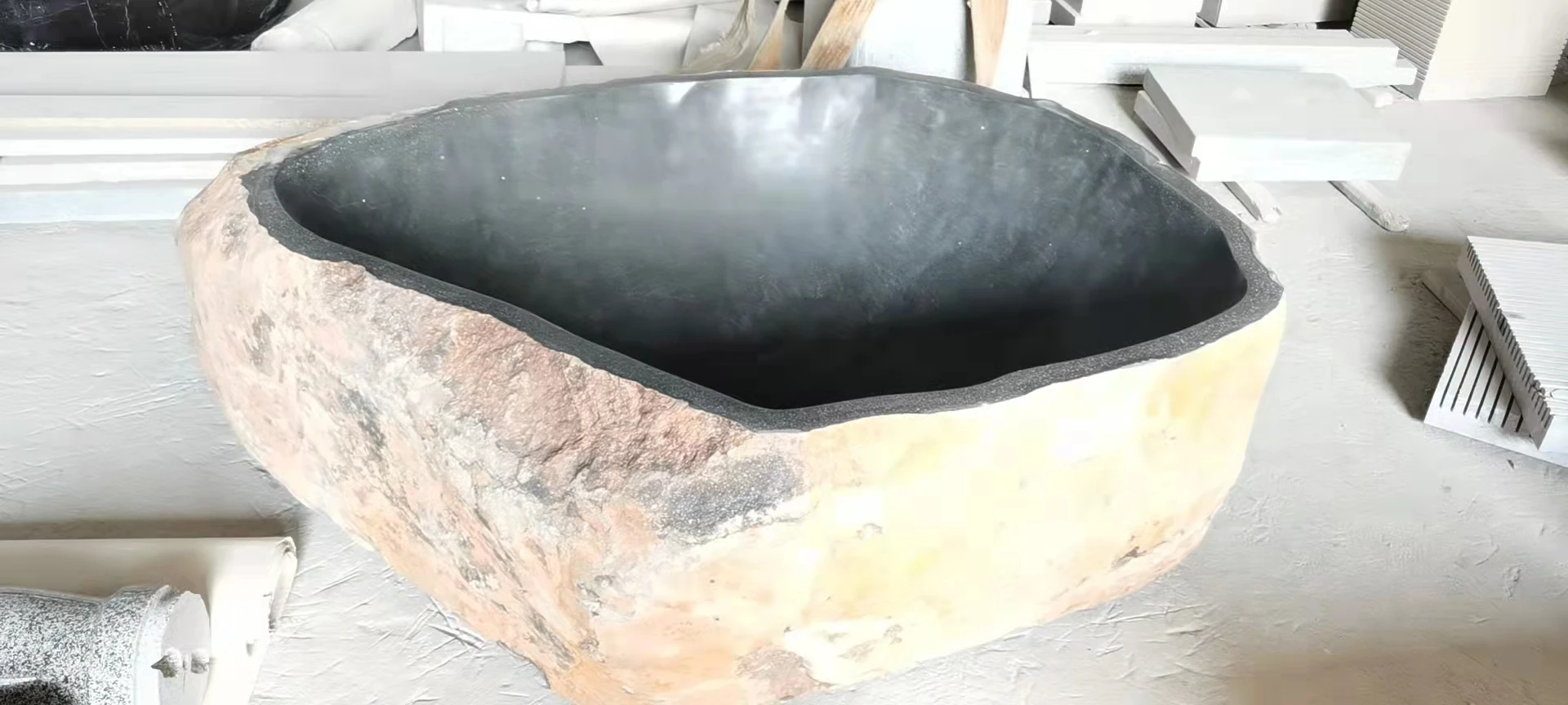 Free standing natural river stone bathtub