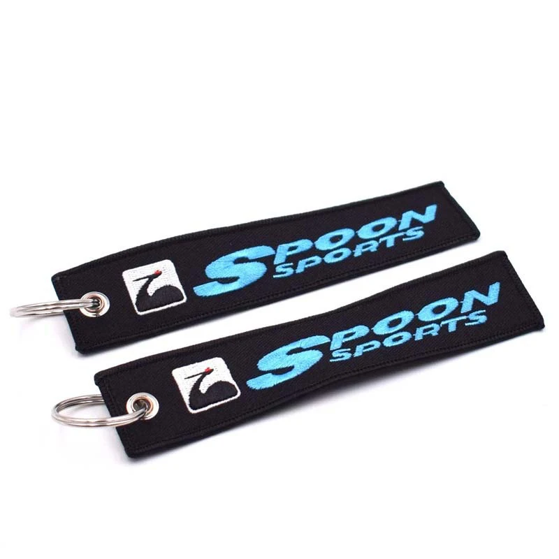 Wholesale customized remove luggage tag label before embroidery keyring flight for logo woven keychains