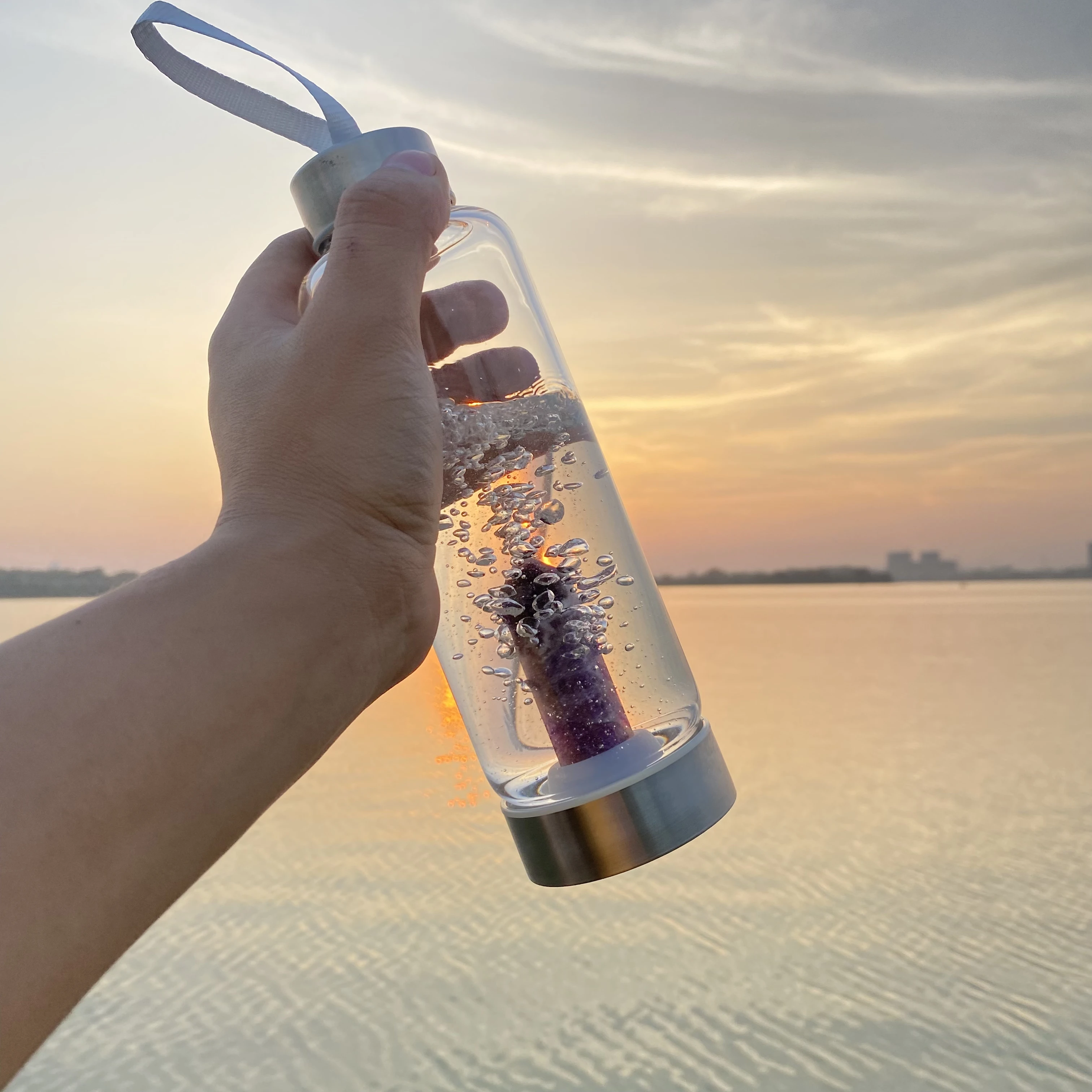 Glass Water Bottle With Rose Quartz Crystal on the Bottom