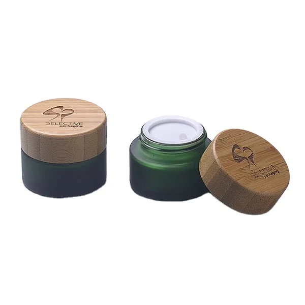 cheap Frosted dark green glass cosmetic packaging cream jars with wood lid suppliers