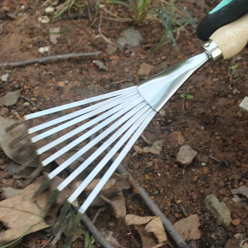Stainless steel three toothed rake and flower
