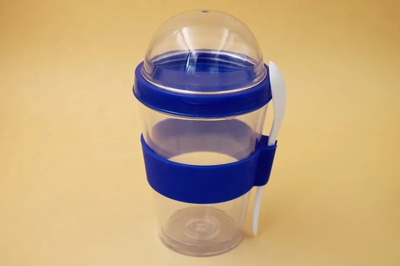 Plastic cereal cup with spoon, travel mug with cruesli compartment