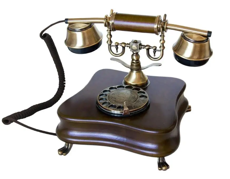 The Old-Fashioned Wall-Mounted Wooden Retro Telephone with Metal Parts with Vintage Rotary Dial and Metal Bell