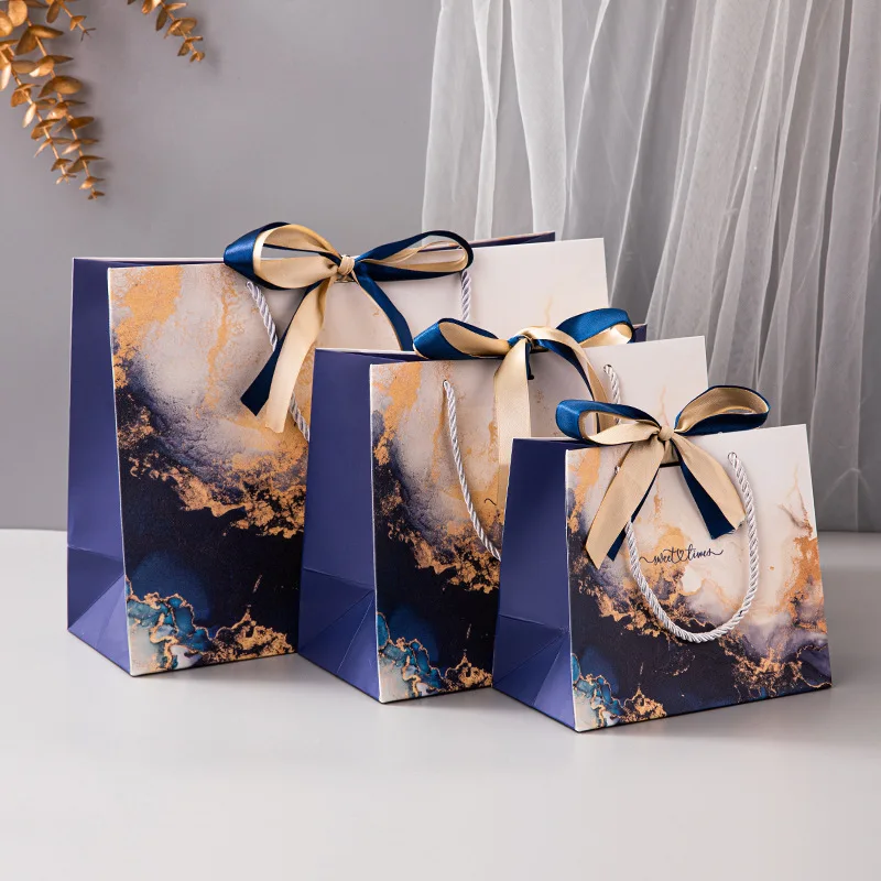 Wholesale Luxury Bulk Square Bottom White Cardboard Offset Printing Clothing Jewelry Paper Gift Bags with Ribbon Bow and Handles