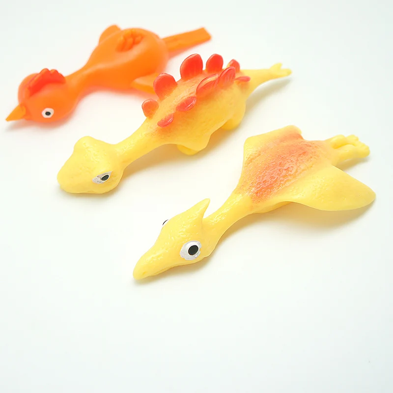Hot Sale TPR Material High Quality Promotion TPR Dinosaur Toy Slingshot Catapult Toys Small Children Toys