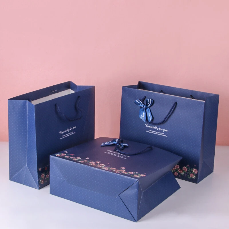 Luxury brand custom logo gift paper bag for clothes blue matte garment clothing boutique packaging bags with ribbon bow