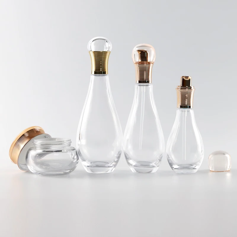 Idealpak Custom High End Gold Luxury Cosmetics Container Glass Bottle Set Glass Bottles Manufacturers with Logo