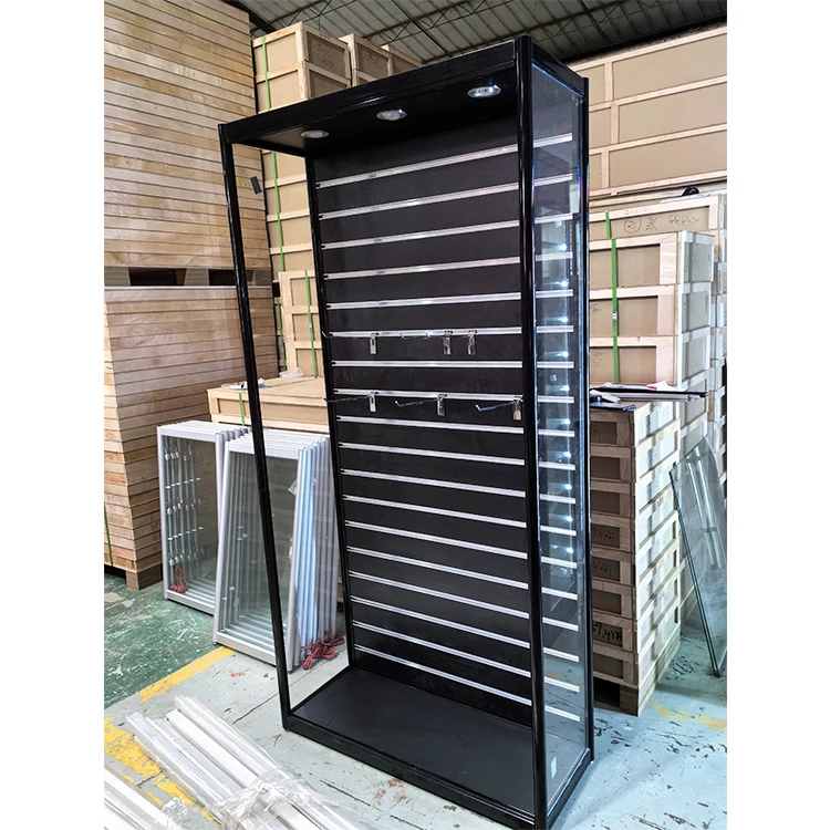 A high-end glass display cabinet with spotlights on the top and slotted back panels that can be stacked with brackets