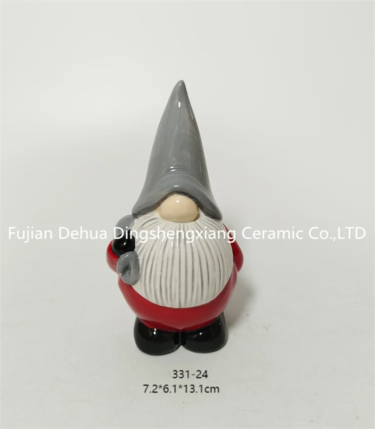 Hand-painted ceramic gnome santa claus with present for holiday decoration