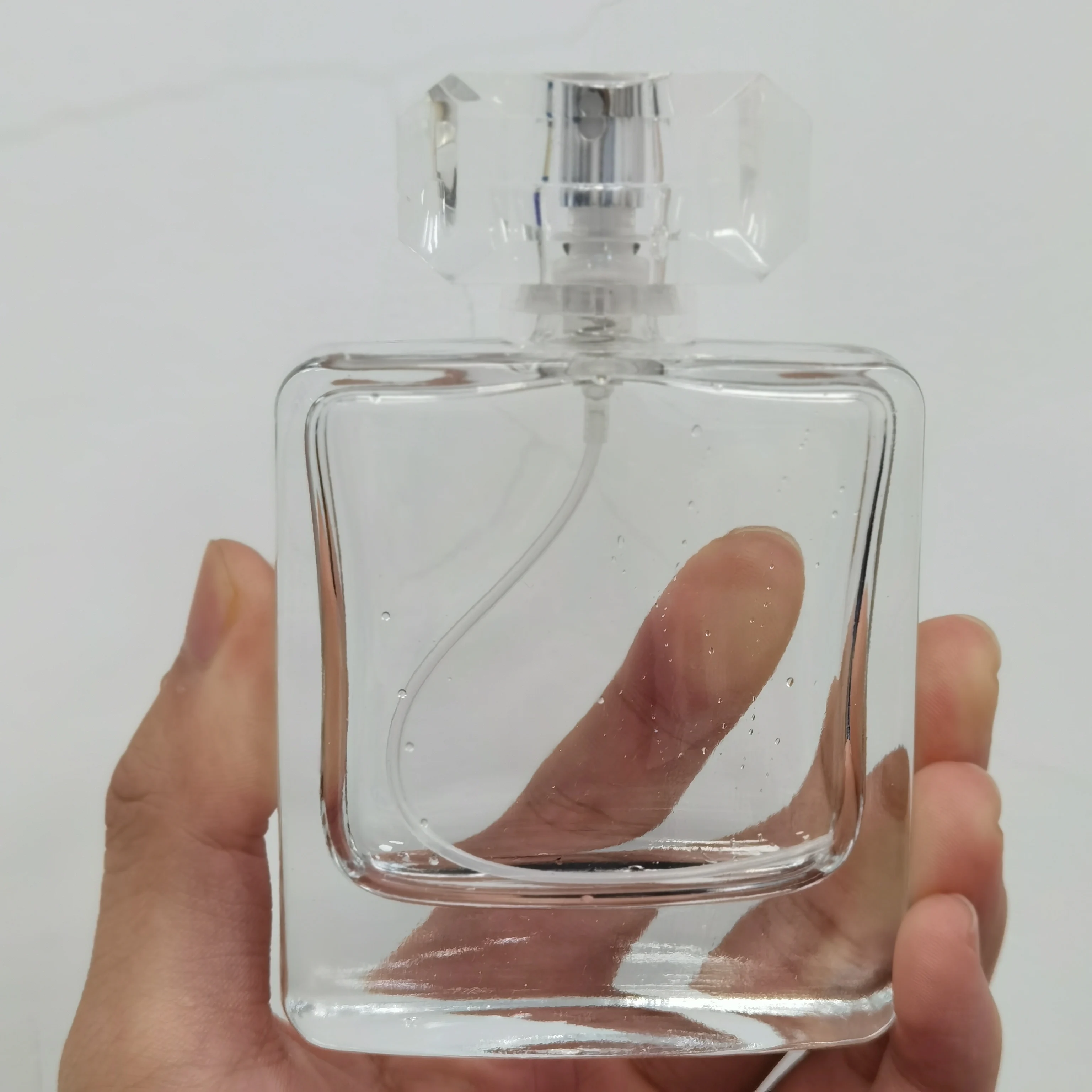Luxury Curved Square Perfume Bottle 50ml Clear Crimp Perfume Spray Bottle with Diamond Cut Cap