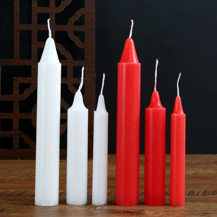 Candlelight candles burn long red and white long rods of wax