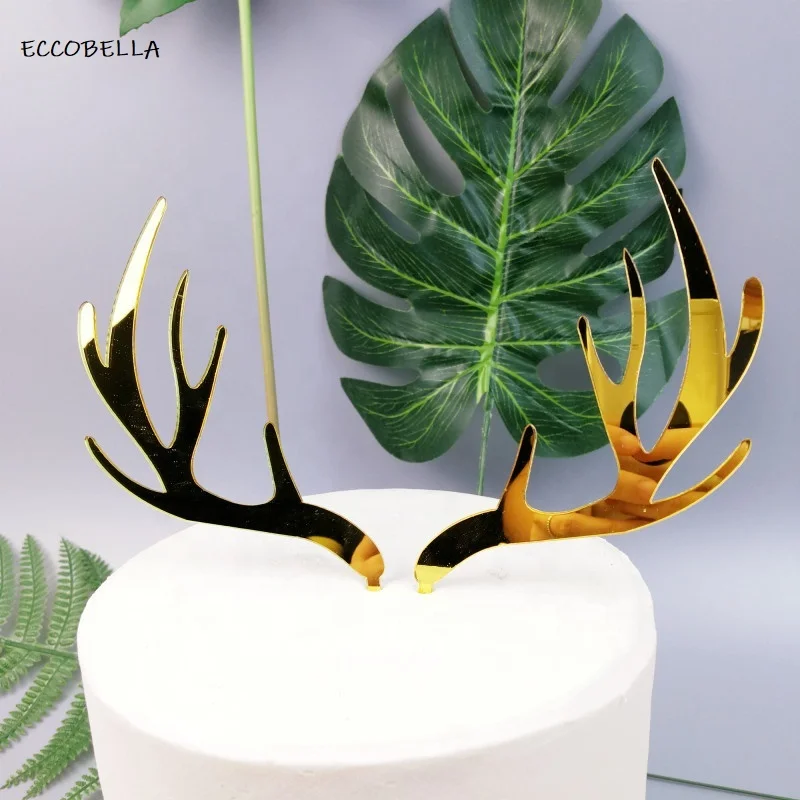 A pair of gold elk acrylic Christmas cake topper for cake decoration