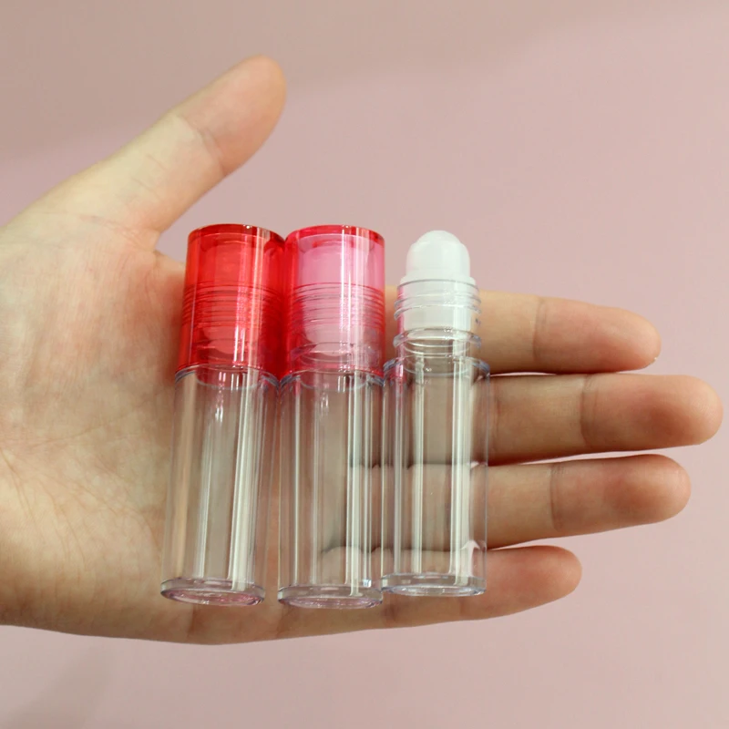 Low moq high quality round clear pink top thick wall lip oil tube  container cosmetic lip gloss packaging roll on lip gloss