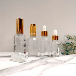 Hot sale luxury custom 10Ml 30ml frosted matte white cosmetic glass serum essential oil bottle with gold dropper and paper tube