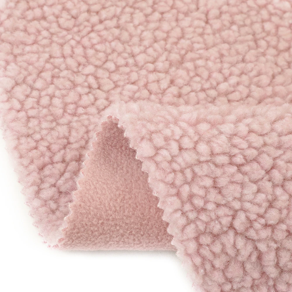 Hot selling winter warm thick polyester solid super soft flannel plush fabric for pajamas