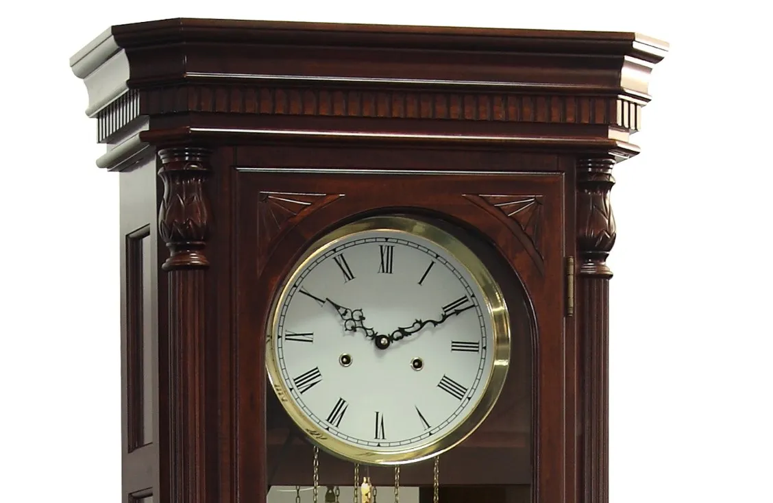 Floor Grandfather Clock door flanked by twin canted columns with turned top and bottom caps completing the traditional de
