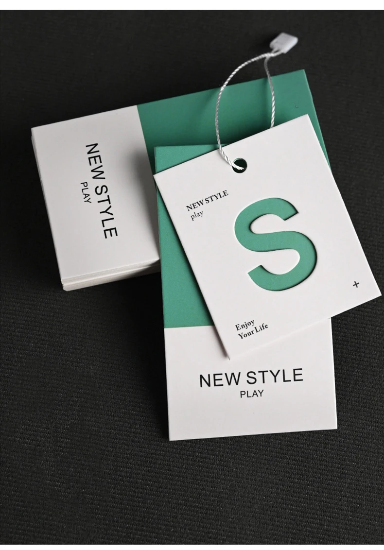 Simplified Letter Hollowed Out Process Embossed Paper Clothing Tag Design Clothing Label Color Printing Clothing Tag