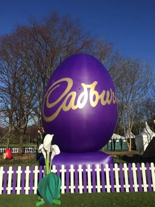 Printed 7m high 14 m long giant inflatable football player helium balloon in a kicking pose for parades