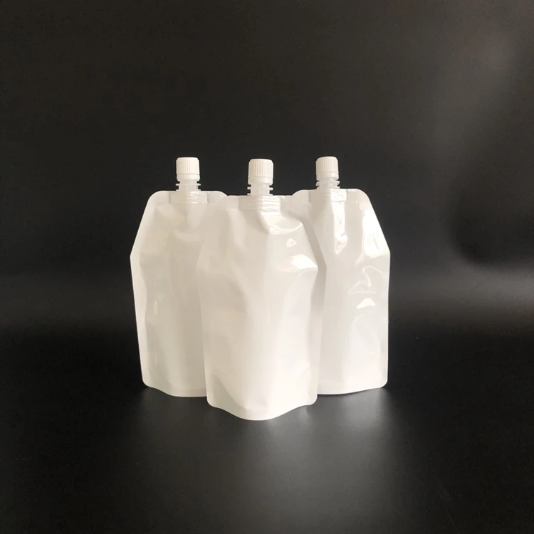 Spot wholesale Custom printed Milky white Self-standing leakproof nylon laminated plastic packaging nozzle liquid bag