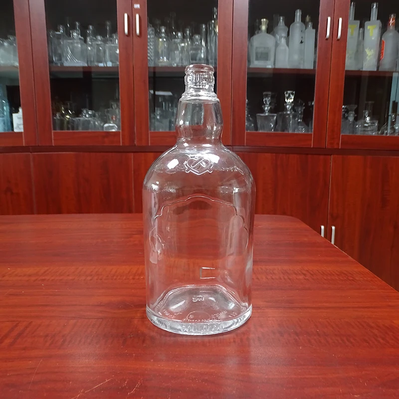 embossed custom brand cheap 1l glass bottle round for whiskey alcohol