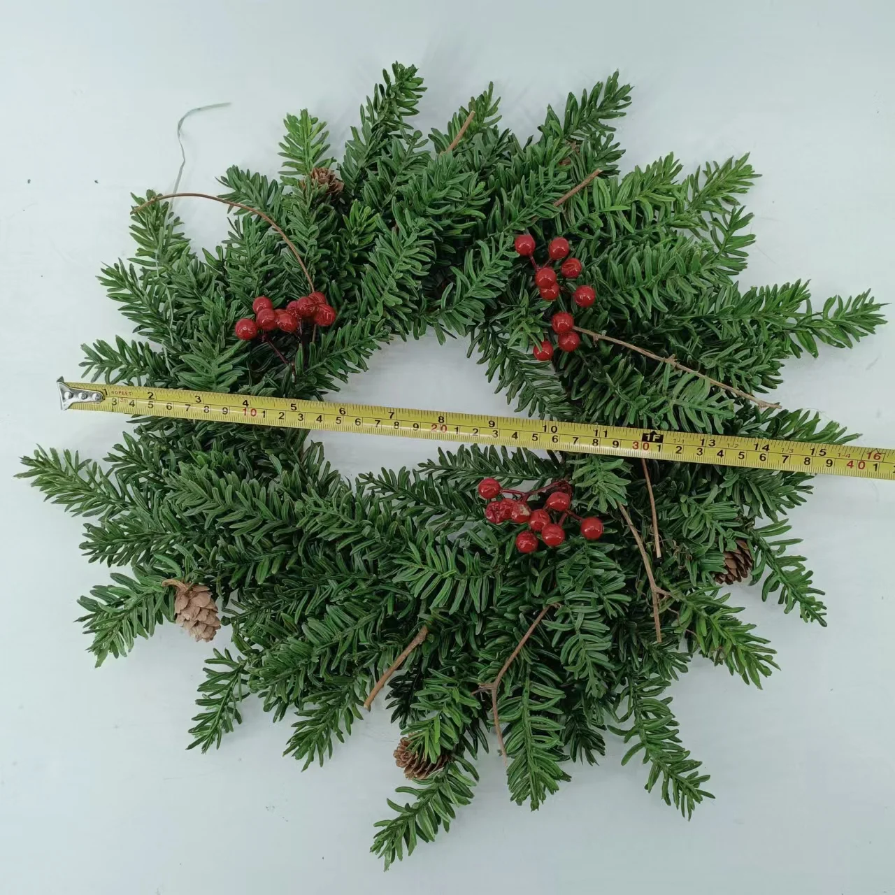 Artificial pine needles and pinecone rings wreath for Christmas