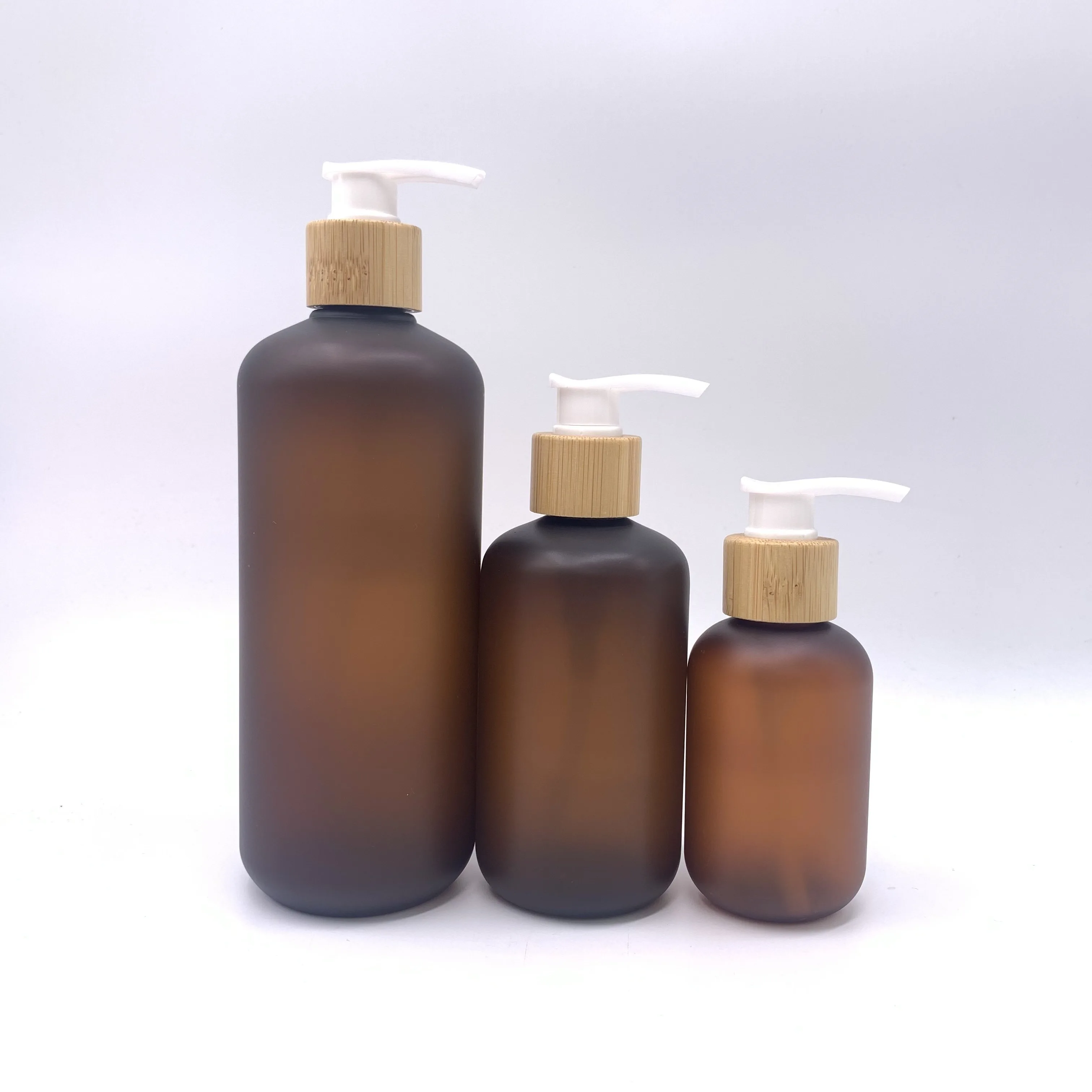 High quality Frosted Brown  100ml 200ml 300ml 500ml Round Shoulder Matte Amber Shampoo Lotion Glass Pump Bottle With Bamboo Lid