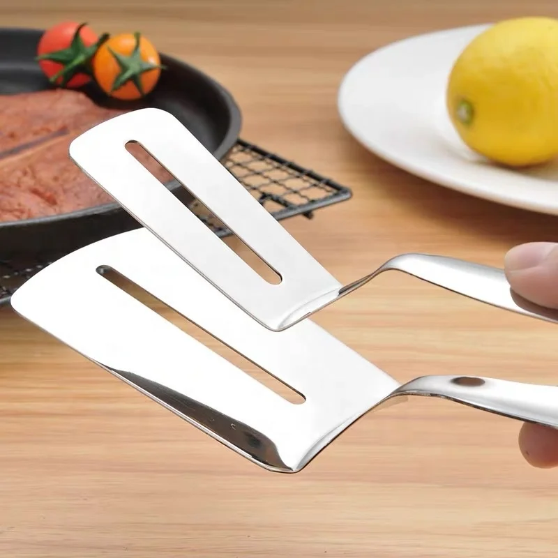 Stainless steel steak spatula barbecue with grilled fish with food with bread pancakes Korean barbecue fried fish with tongs