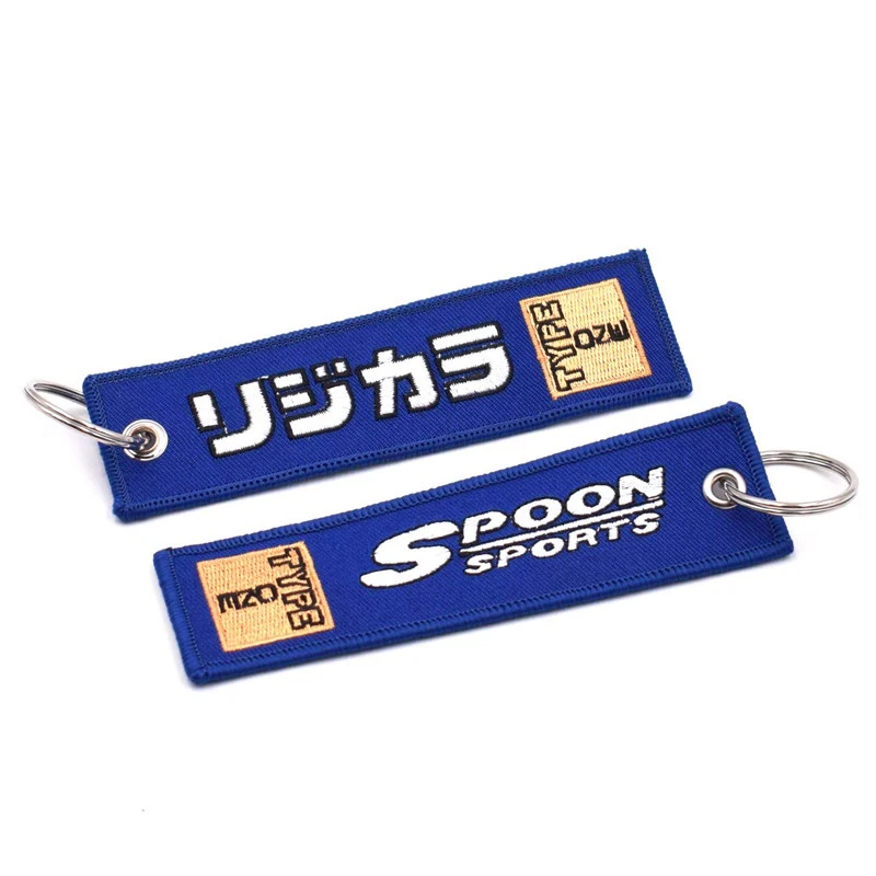Wholesale customized remove luggage tag label before embroidery keyring flight for logo woven keychains