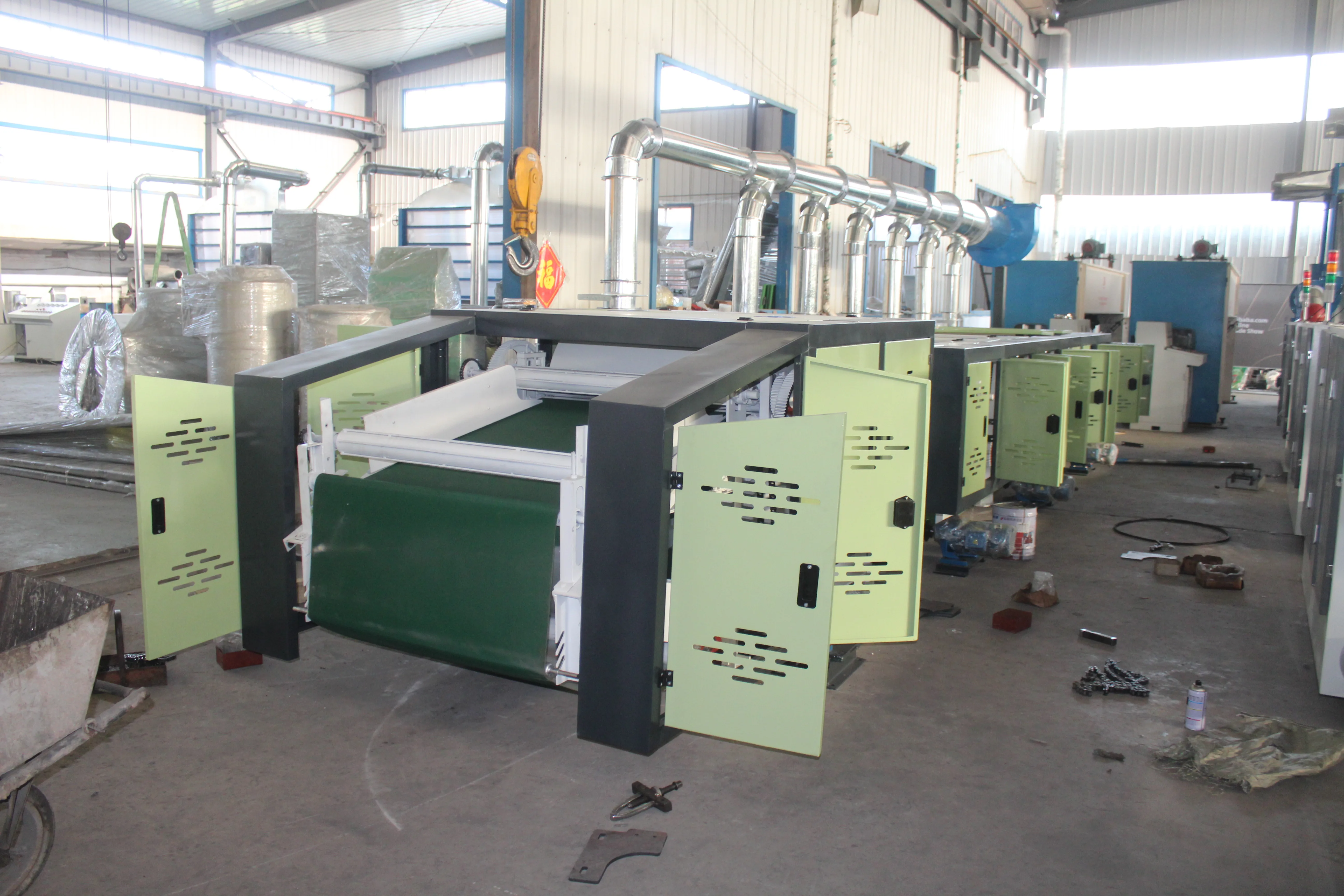 Textile waste old clothes jeans mattress scraps are recycled and opened into fibers textile recycling machine line