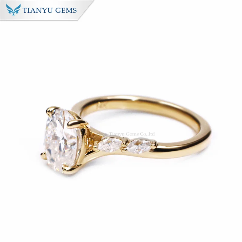 Tianyu gems yellow gold Oval centre diamond with Marquise cut stones on the shoulders engagement ring