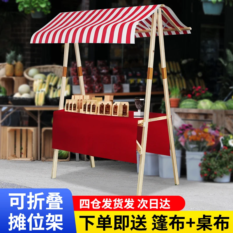 Wooden market stand stall with orange white striped awning retail business concept