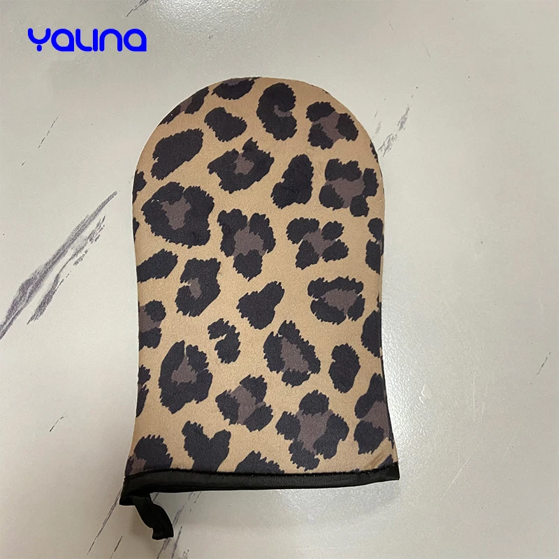 Reusable applicator glove evenly applies natural bronzed streak free appearance Leopard tanning mitt