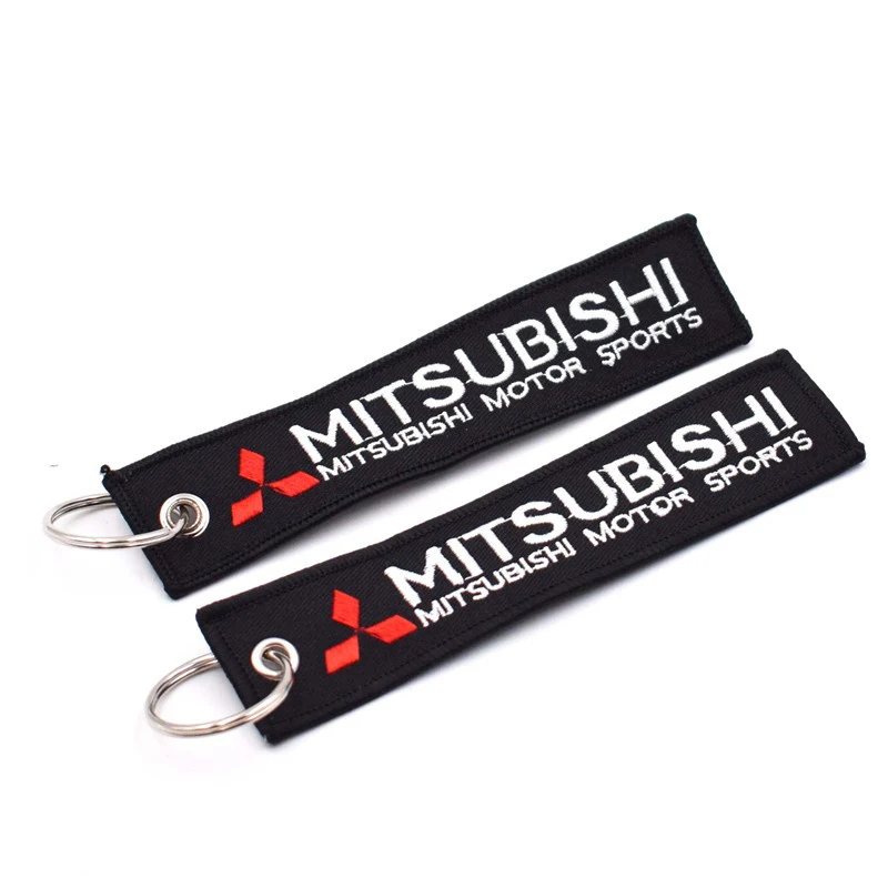 Wholesale customized remove luggage tag label before embroidery keyring flight for logo woven keychains