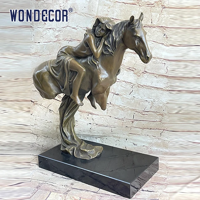 A copper sculpture of a young girl on a large metal art horse back outdoors
