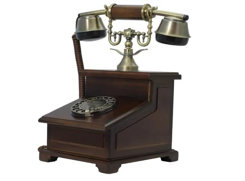 The Old-Fashioned Wall-Mounted Wooden Retro Telephone with Metal Parts with Vintage Rotary Dial and Metal Bell