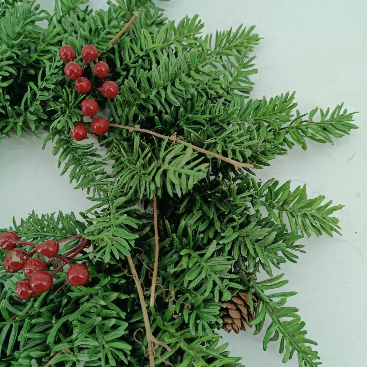 Artificial pine needles and pinecone rings wreath for Christmas