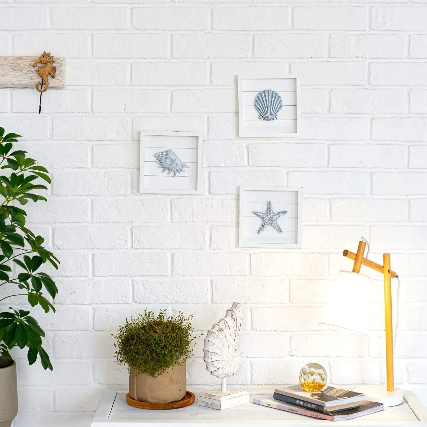 Beach wall decorated with blue shells and starfish, 3 white wooden frames, suitable for bathroom or coastal bedroom, home