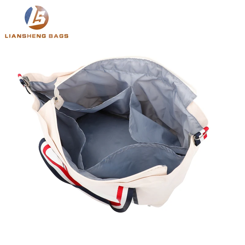 
Large canvas bag with separate layer of shoes and umbrellas underneath 