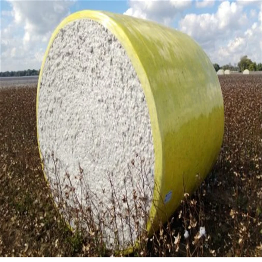 Yellow harvested cotton bales wrapped films