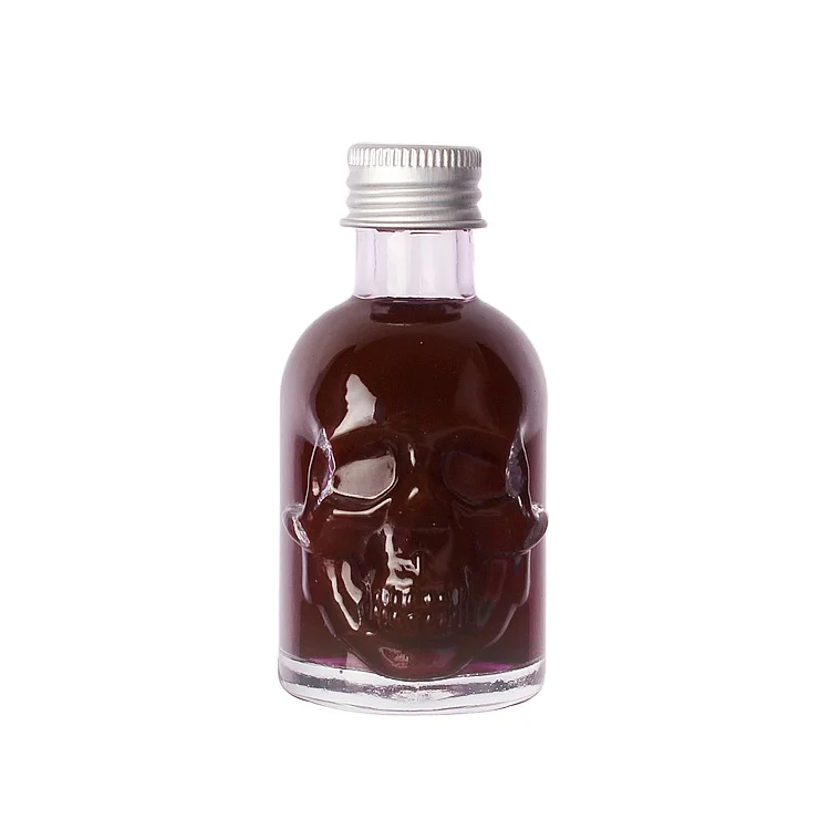 Wholesale 50ml Skull shape small sample alcoholic beverage bottle glass wine bottle with lids